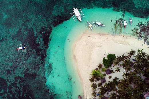 Aerial view of Guyam Island with bancas moored on the sandbar, Siargao