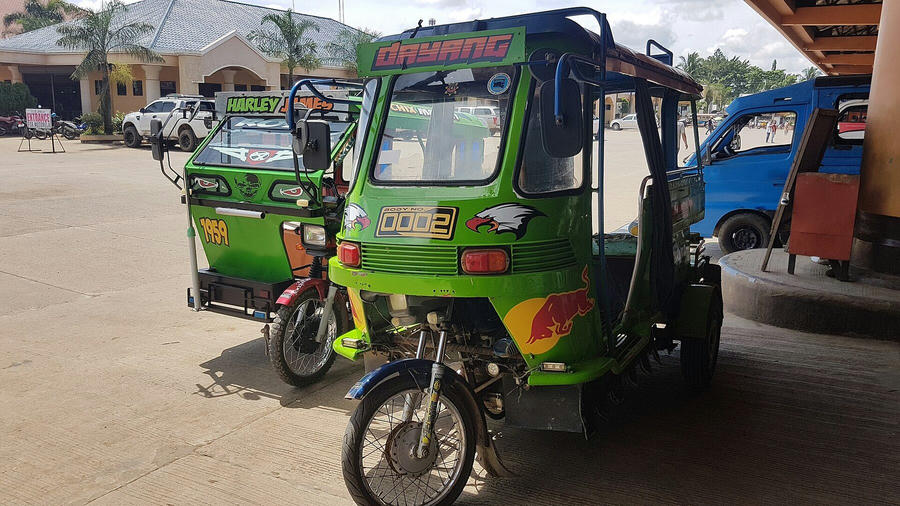 A motorised tricycle, the standard short-hop transport across the Philippines