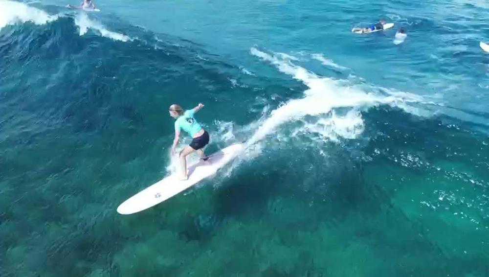 A surfer trimming along a clean wave face at Siargao
